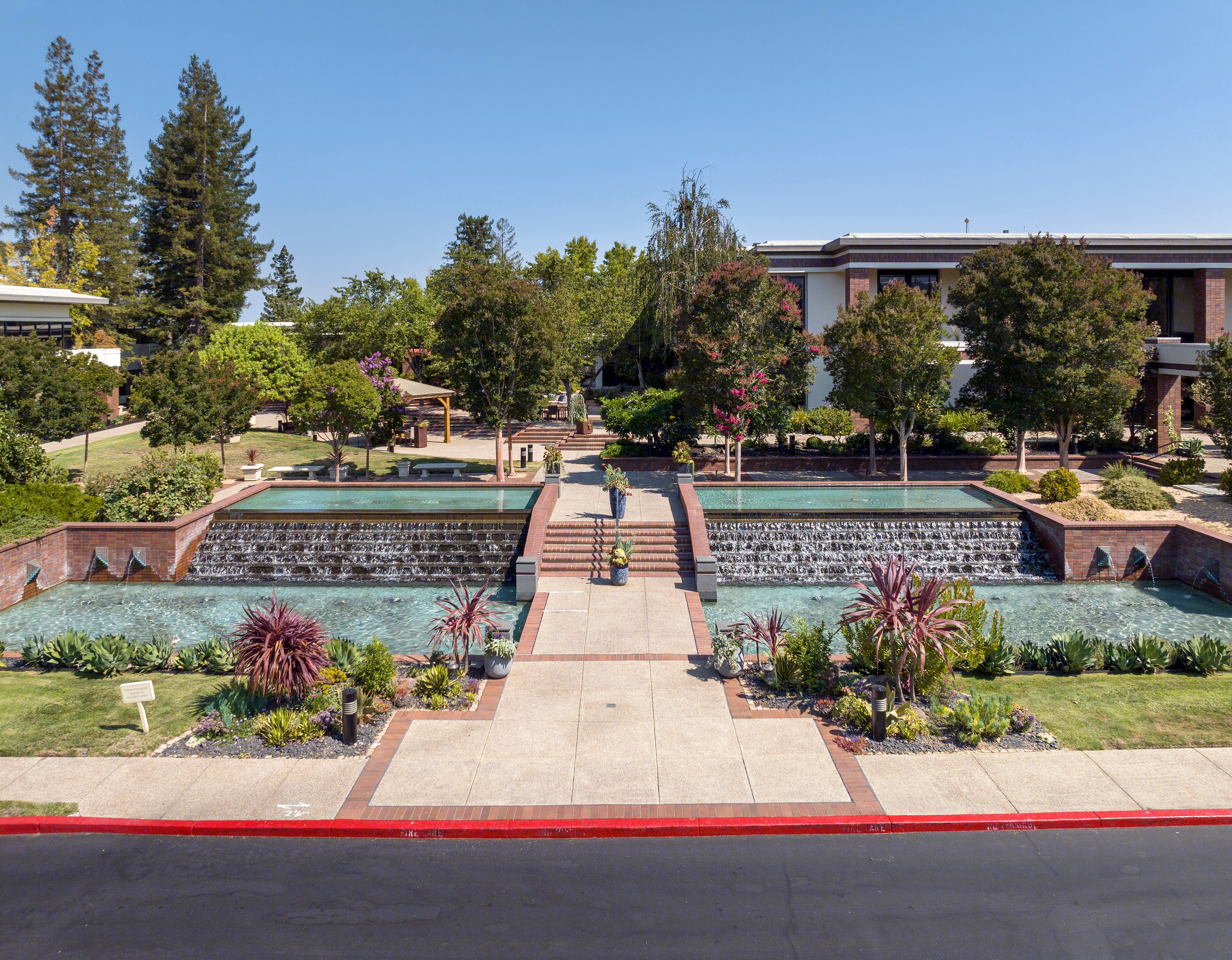 A view of the outdoor landscape entrance on a clear sunny day.
